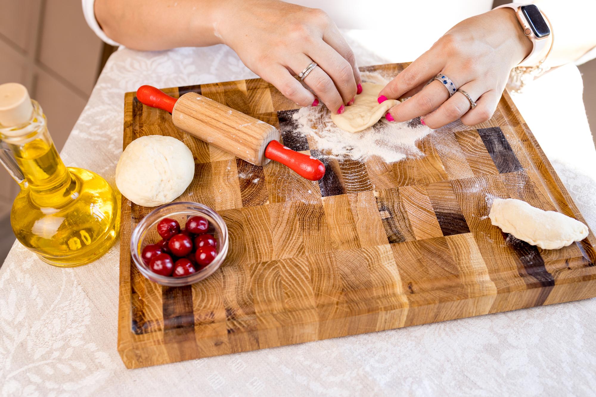 Chef al lavoro su un bancone in legno, strumenti e ingredienti disposti con cura
